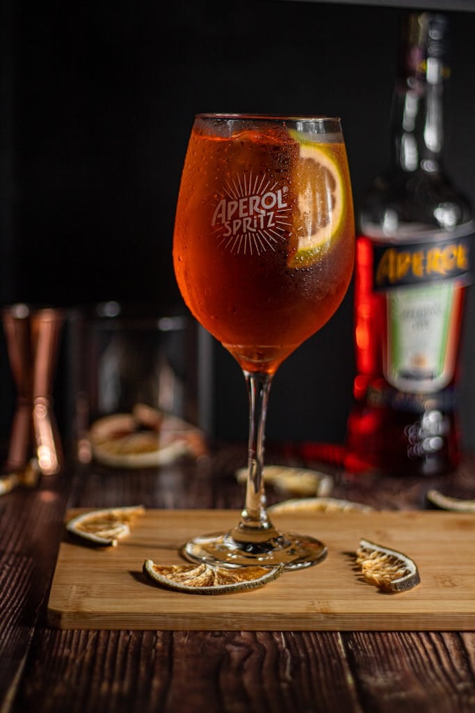 A close-up of a refreshing Aperol Spritz cocktail garnished with an orange slice, perfect for aperitifs.